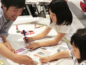 世代を超えてだれもが楽しめる「まわしよみ新聞」。小さな子供も夢中になる＝７月、札幌の体験会